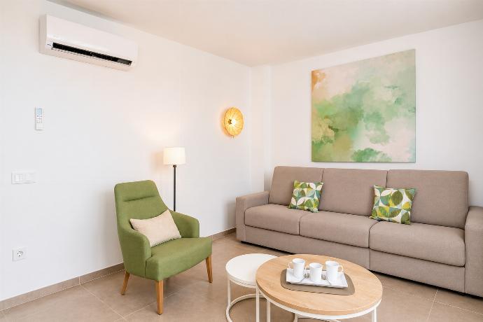 Open-plan living room with sofa, kitchen, A/C, WiFi and TV . - Ereza Residence 3.4 . (Photo Gallery) }}