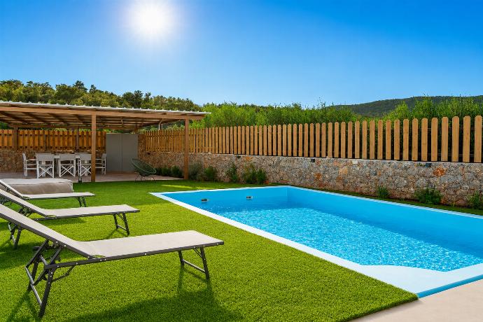 Sunny private pool area with sun loungers, shaded outdoor dining, and peaceful green surroundings. . - Villa Galini . (Galería de imágenes) }}