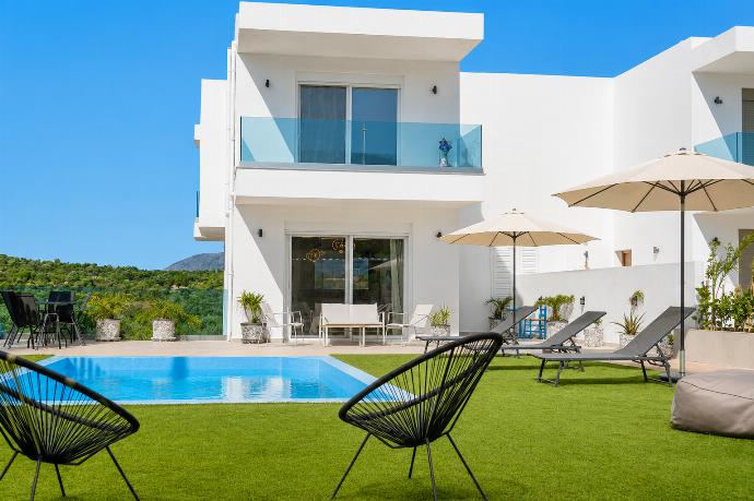 Modern villa with a private pool, sun loungers, and a peaceful landscaped garden. . - Villa Galini . (Galería de imágenes) }}