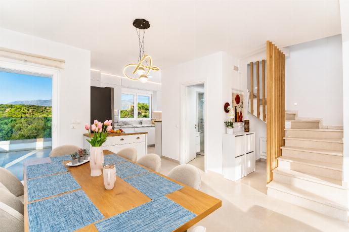 Bright dining area with modern lighting, stylish decor, and beautiful countryside views. . - Villa Galini . (Galería de imágenes) }}