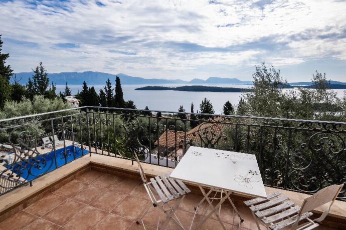 Wrought iron balcony with a white table overlooking a scenic sea view. . - Villa Galatia . (Photo Gallery) }}