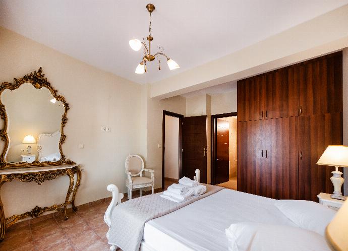 Villa bedroom with a large wood wardrobe and an ornate gold-framed vanity mirror. . - Villa Galatia . (Photo Gallery) }}