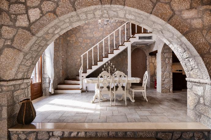 Stone archway framing an elegant white dining table and rustic staircase. . - Villa Galatia . (Photo Gallery) }}