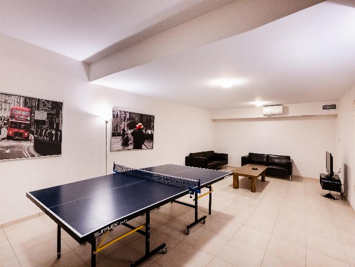Spacious games room featuring a ping-pong table and a leather sofa lounge area. . - Villa Galatia . (Photo Gallery) }}