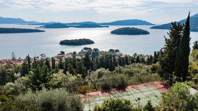 Private outdoor tennis court overlooking a panoramic sea bay with scattered green islands. . - Villa Galatia . (Photo Gallery) }}