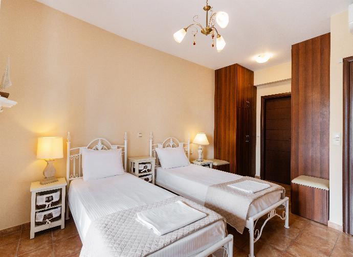 Twin bedroom featuring ornate white metal bed frames and dark wood wardrobes. . - Villa Galatia . (Photo Gallery) }}