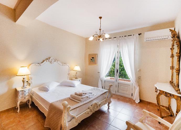Elegant bedroom featuring an ornate white bed frame and balcony doors. . - Villa Galatia . (Photo Gallery) }}