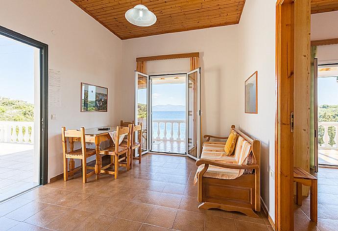 Living room with dining area, WiFi Internet, terrace access, and sea views . - Dolphin Villa 3 . (Photo Gallery) }}