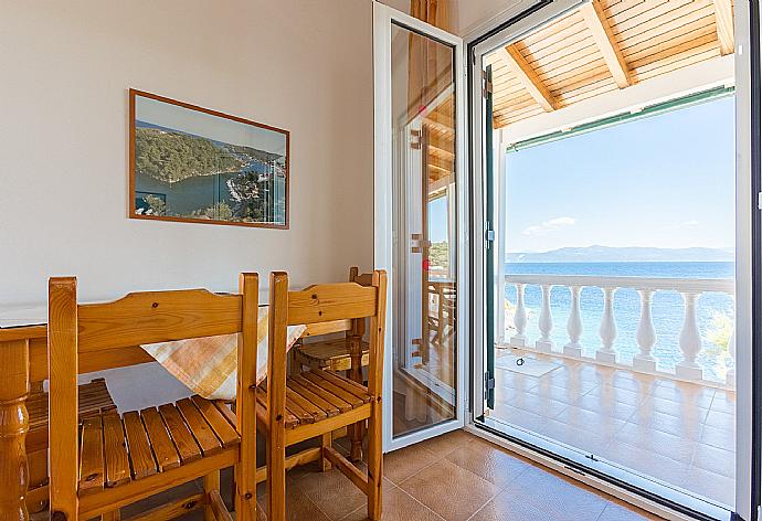 Living room with dining area, WiFi Internet, terrace access, and sea views . - Dolphin Villa 3 . (Photo Gallery) }}