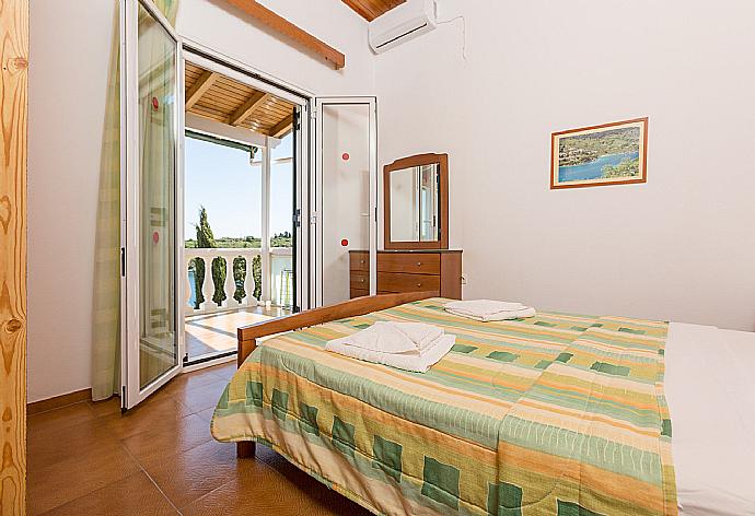 Double bedroom with A/C and balcony access . - Dolphin Villa 3 . (Photo Gallery) }}