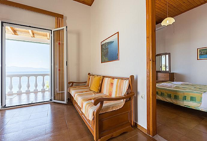 Living room with dining area, WiFi Internet, terrace access, and sea views . - Dolphin Villa 3 . (Photo Gallery) }}