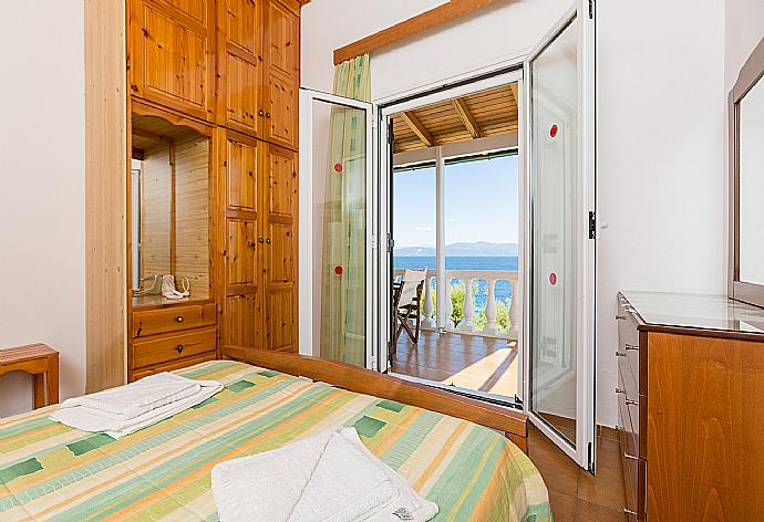 Double bedroom with A/C and balcony access . - Dolphin Villa 3 . (Photo Gallery) }}