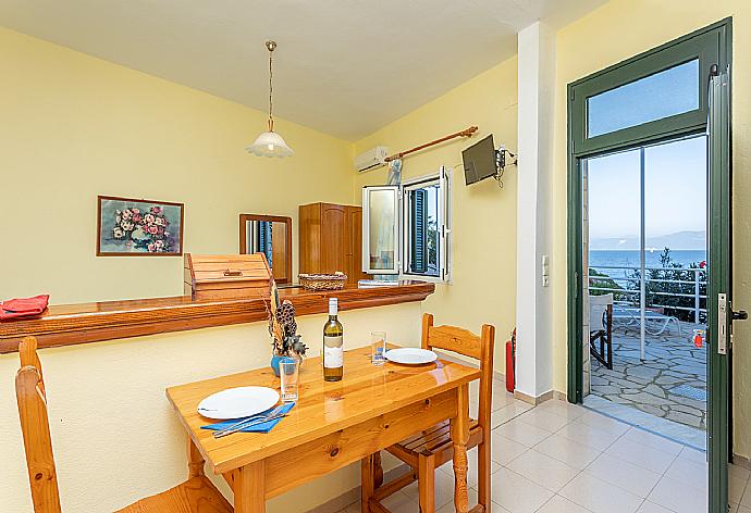 Open-plan studio with twin beds, dining area, kitchen, A/C, WiFi internet, satellite TV, and sea views . - Dolphin Studio . (Photo Gallery) }}