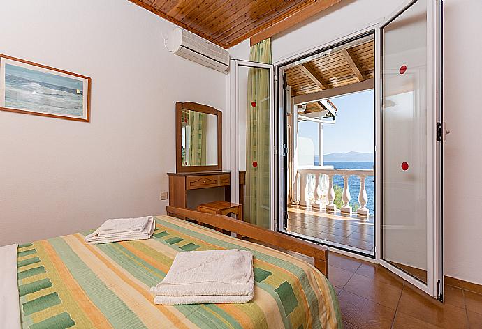 Double bedroom with A/C and balcony access with sea views . - Dolphin Villa 2 . (Photo Gallery) }}