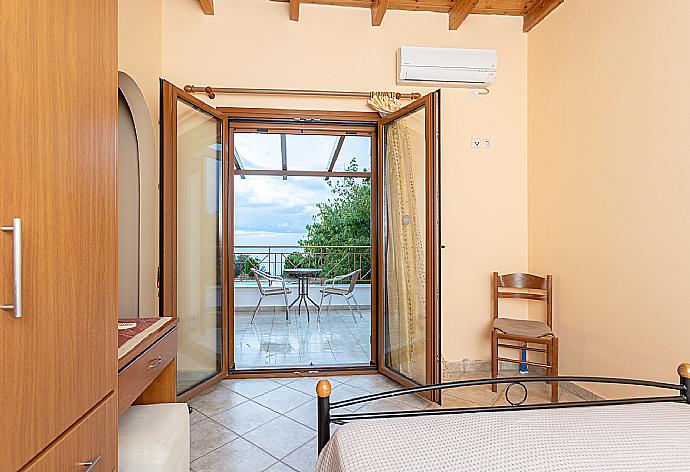 Double bedroom with en suite bathroom, A/C, sea views, and terrace access . - Villa Aetos . (Photo Gallery) }}