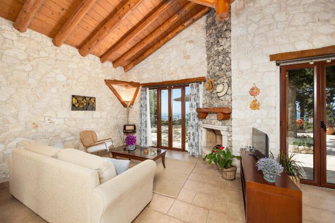 Open-plan villa with sofa, dining area, kitchen, double bed, bathroom, ornamental fireplace, A/C, WiFi internet, satellite TV, and sea views . - Villa Gallini . (Photo Gallery) }}