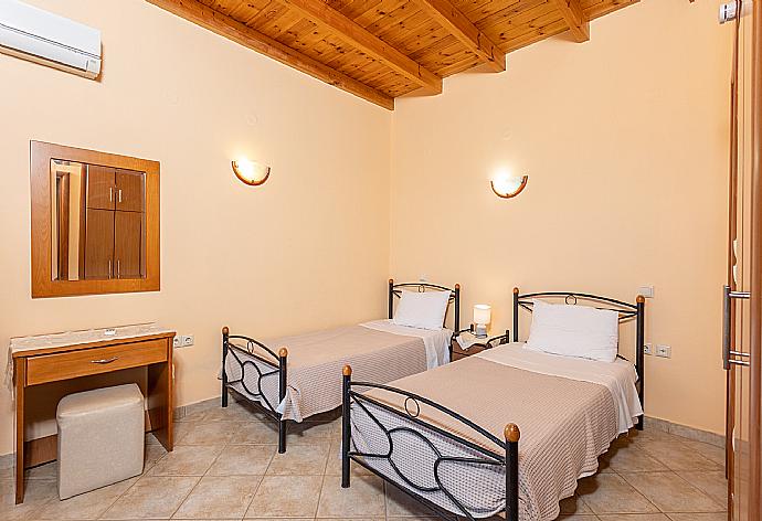 Twin bedroom with en suite bathroom, A/C, sea views, and upper terrace access . - Villa Yeraki . (Photo Gallery) }}