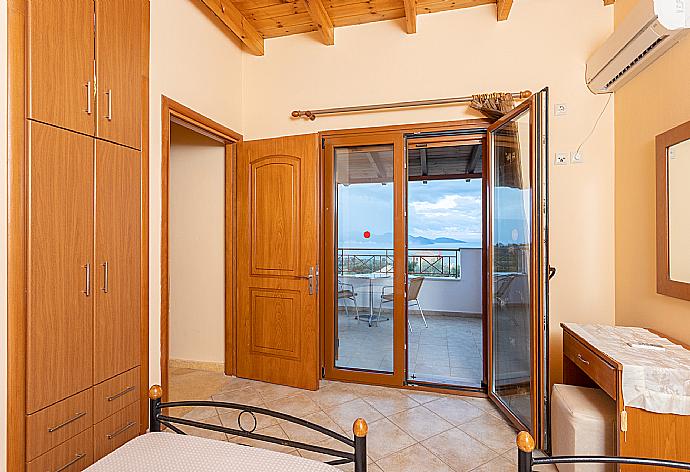 Twin bedroom with en suite bathroom, A/C, sea views, and upper terrace access . - Villa Yeraki . (Photo Gallery) }}