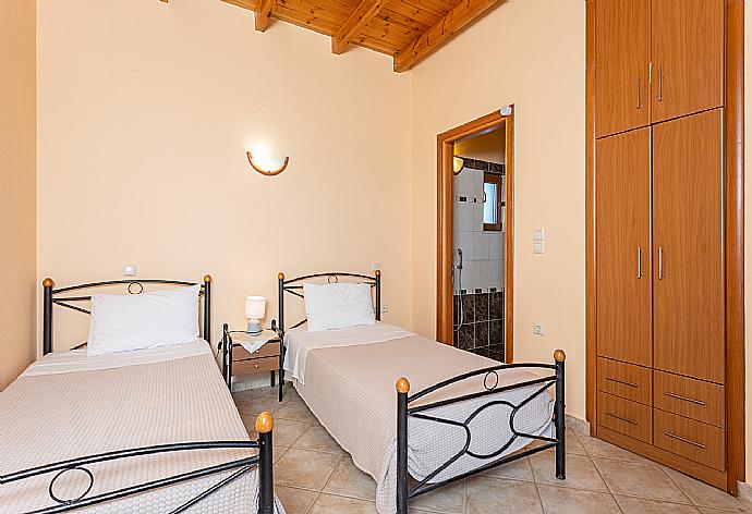 Twin bedroom with en suite bathroom, A/C, sea views, and upper terrace access . - Villa Yeraki . (Photo Gallery) }}