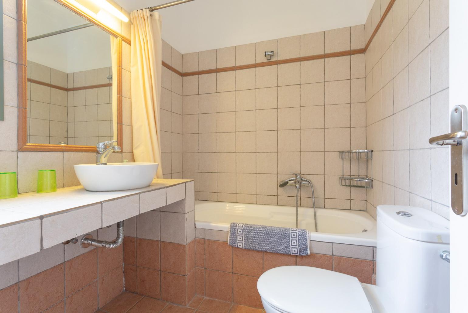 Family bathroom with bath and overhead shower