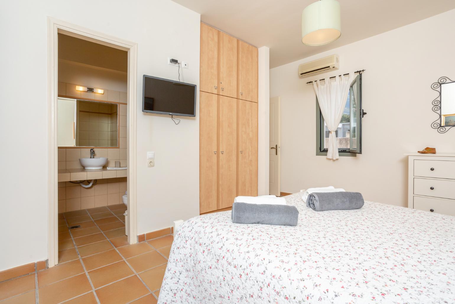 Double bedroom with en suite bathroom, A/C, TV, and terrace access