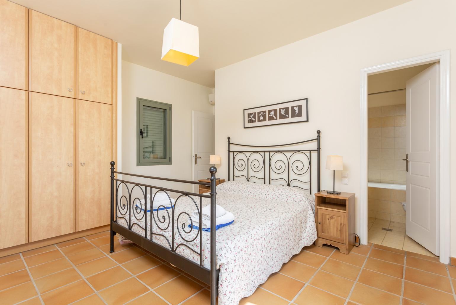 Double bedroom with en suite bathroom, A/C, and upper terrace access with sea views