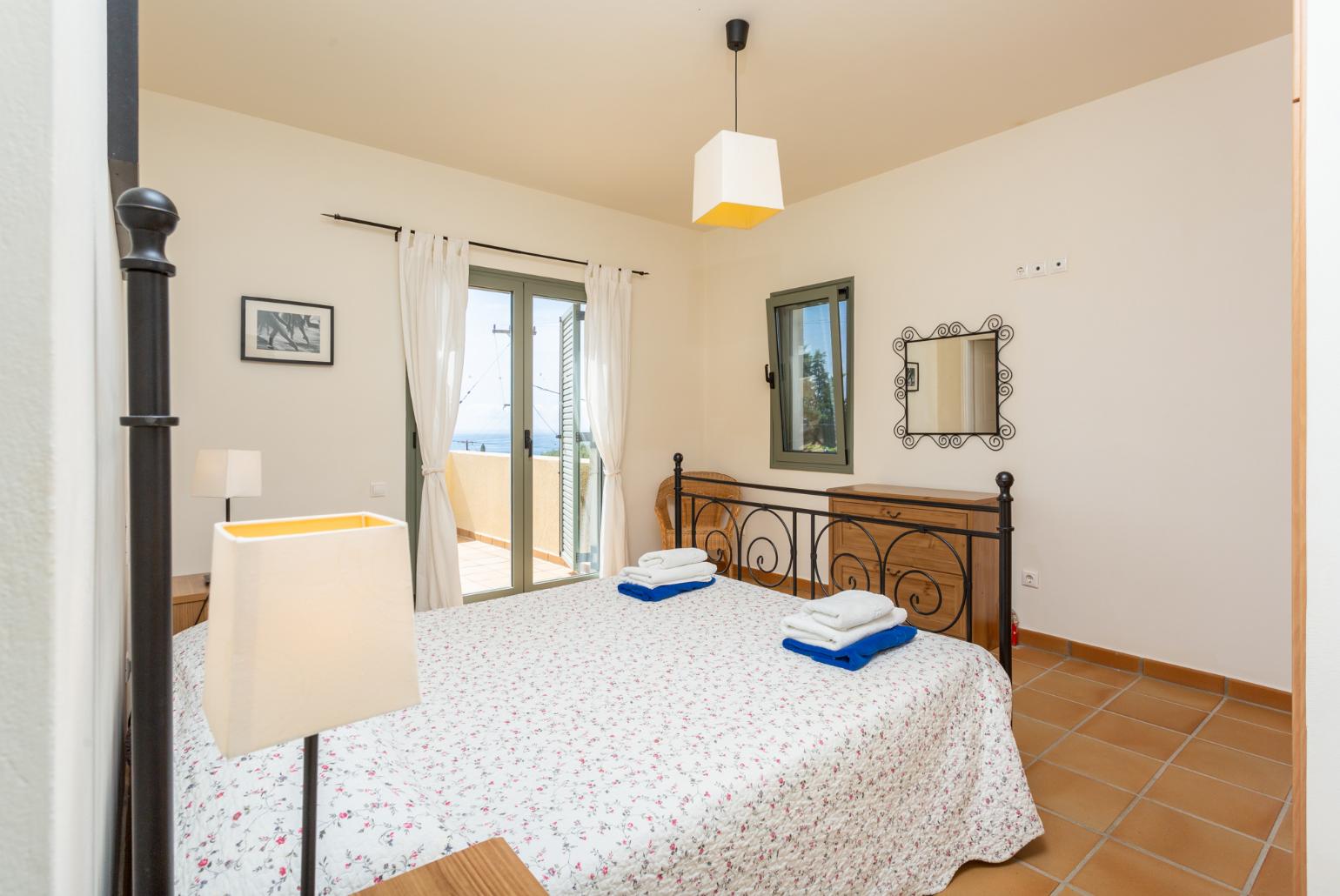 Double bedroom with en suite bathroom, A/C, and upper terrace access with sea views
