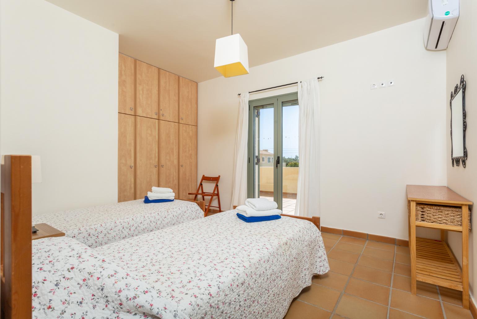 Twin bedroom with en suite bathroom, A/C, and upper terrace access with sea views