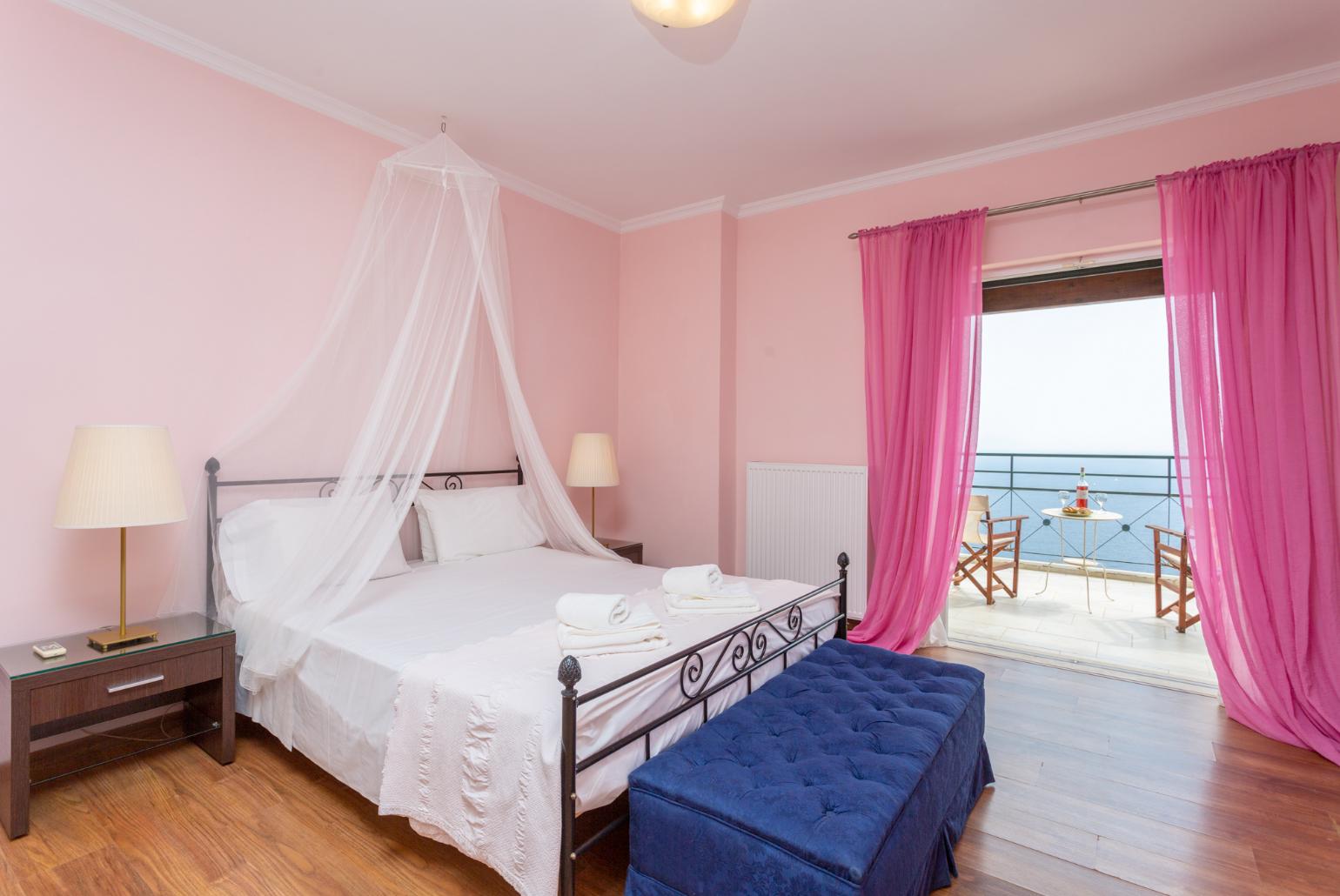 Double bedroom with en suite bathroom, A/C, and balcony access with panoramic sea views