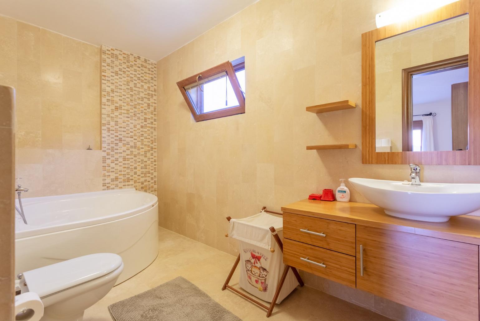 En suite bathroom with spa bath and shower