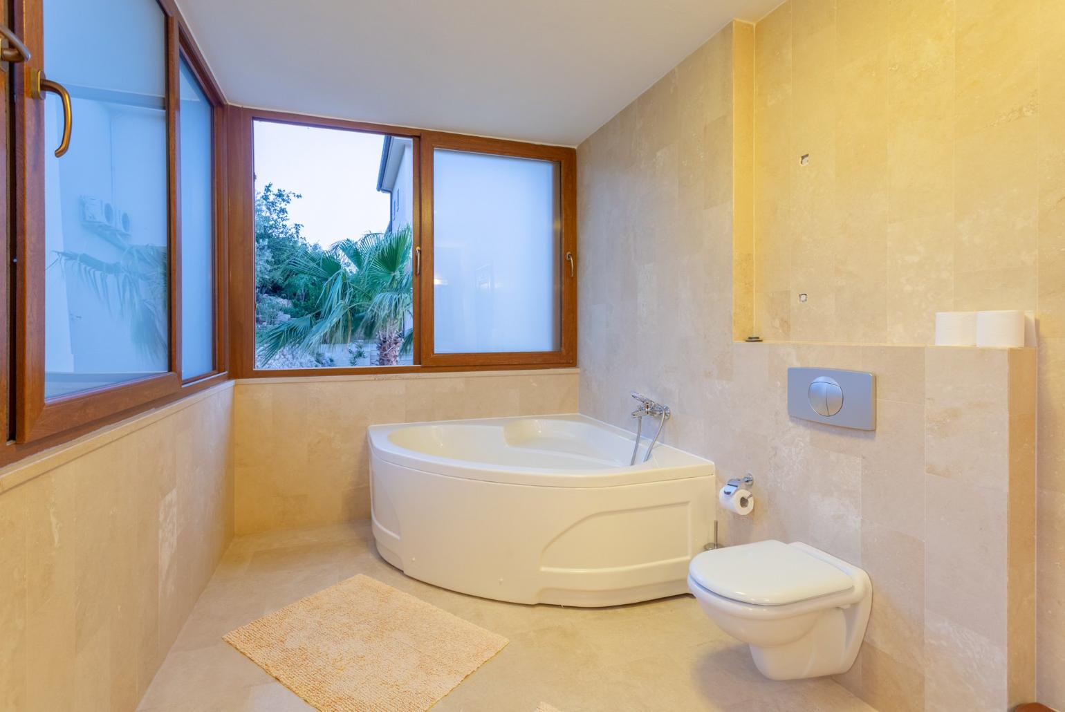 En suite bathroom with spa bath and shower