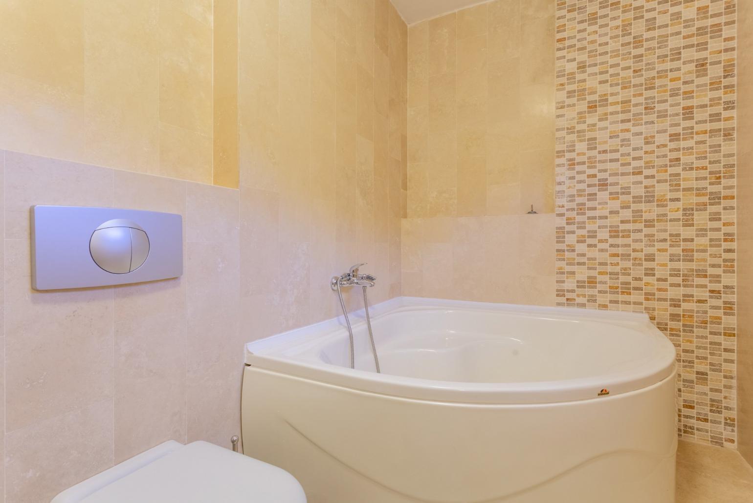 En suite bathroom with spa bath and shower