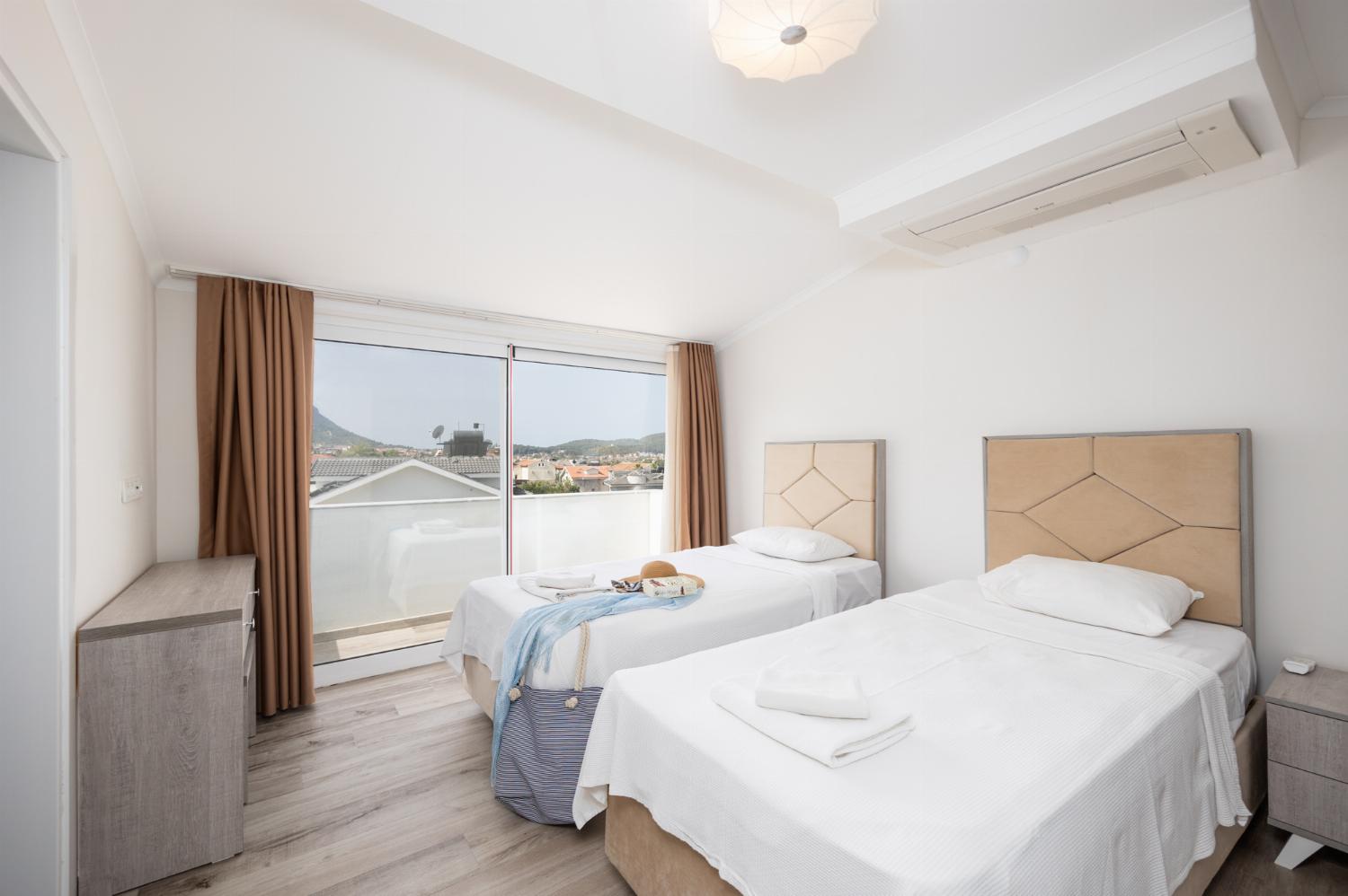 Twin bedroom with en suite bathroom and A/C