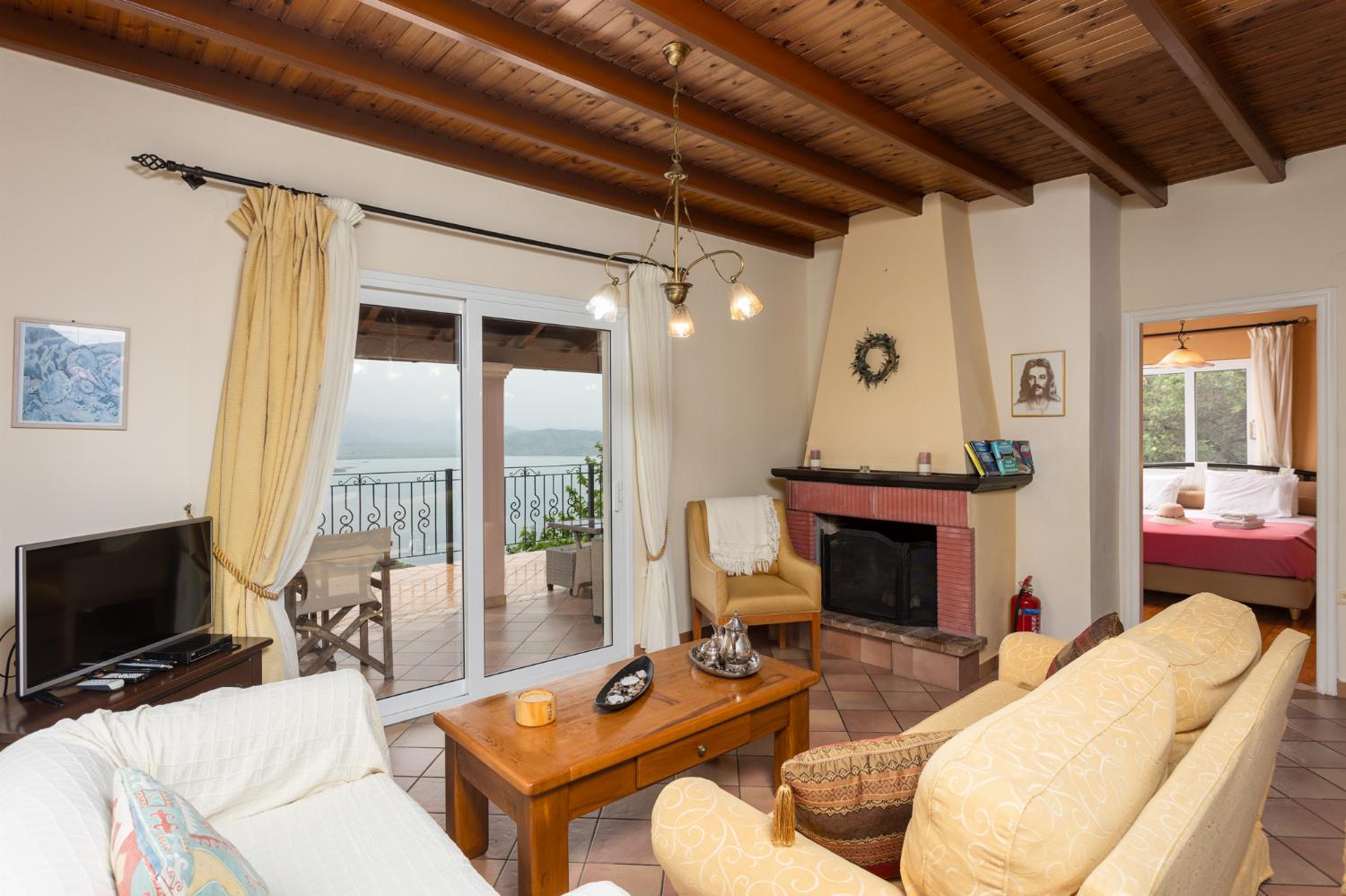 Living room on first floor with sofas, dining area, ornamental fireplace, WiFi internet, satellite TV, and sea views