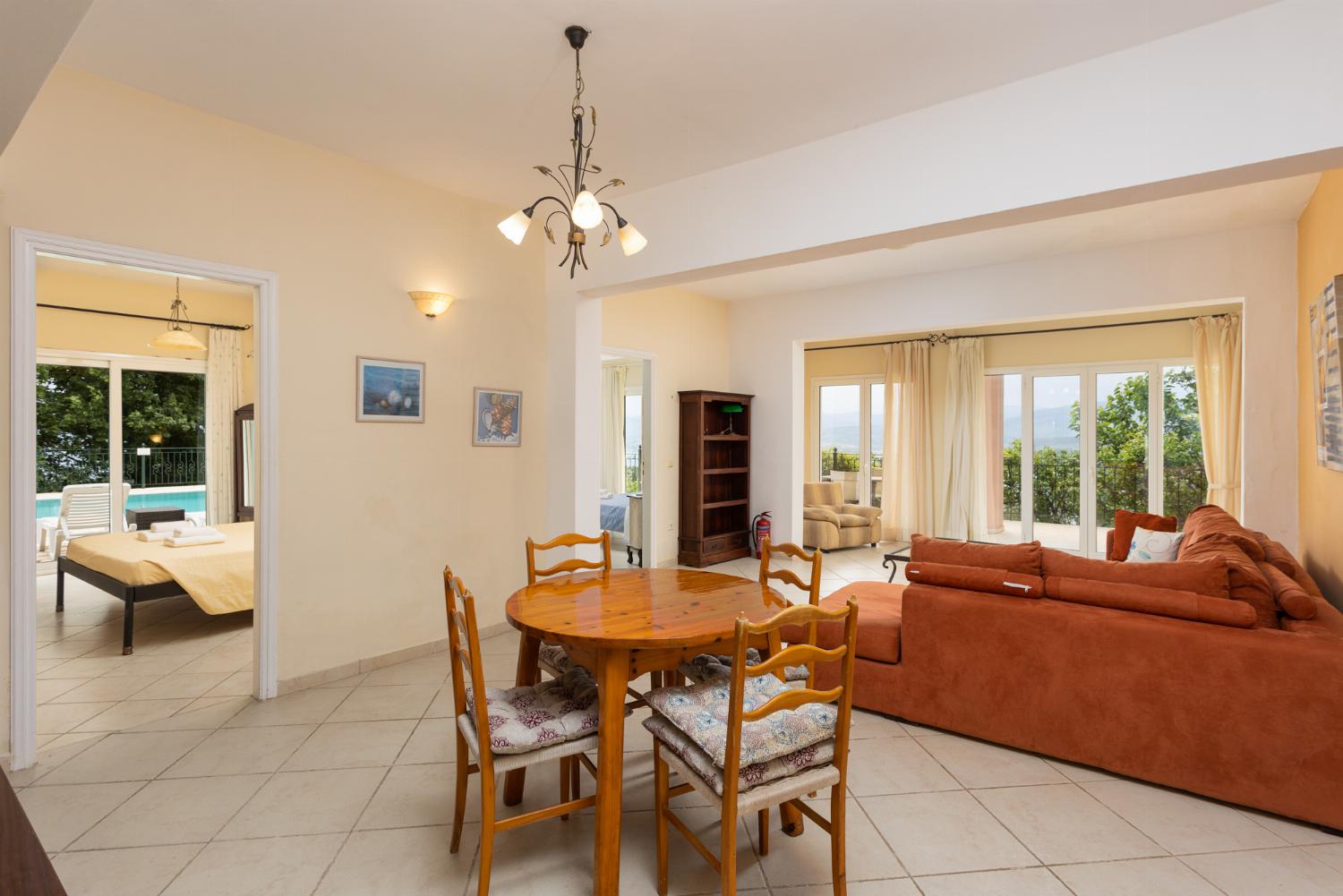 Living room on ground floor with sofa, dining area, and kitchenette