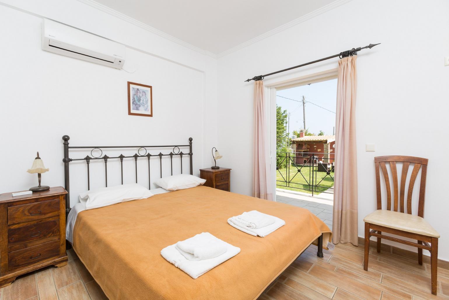 Double bedroom on ground floor with en suite bathroom, A/C, and terrace access