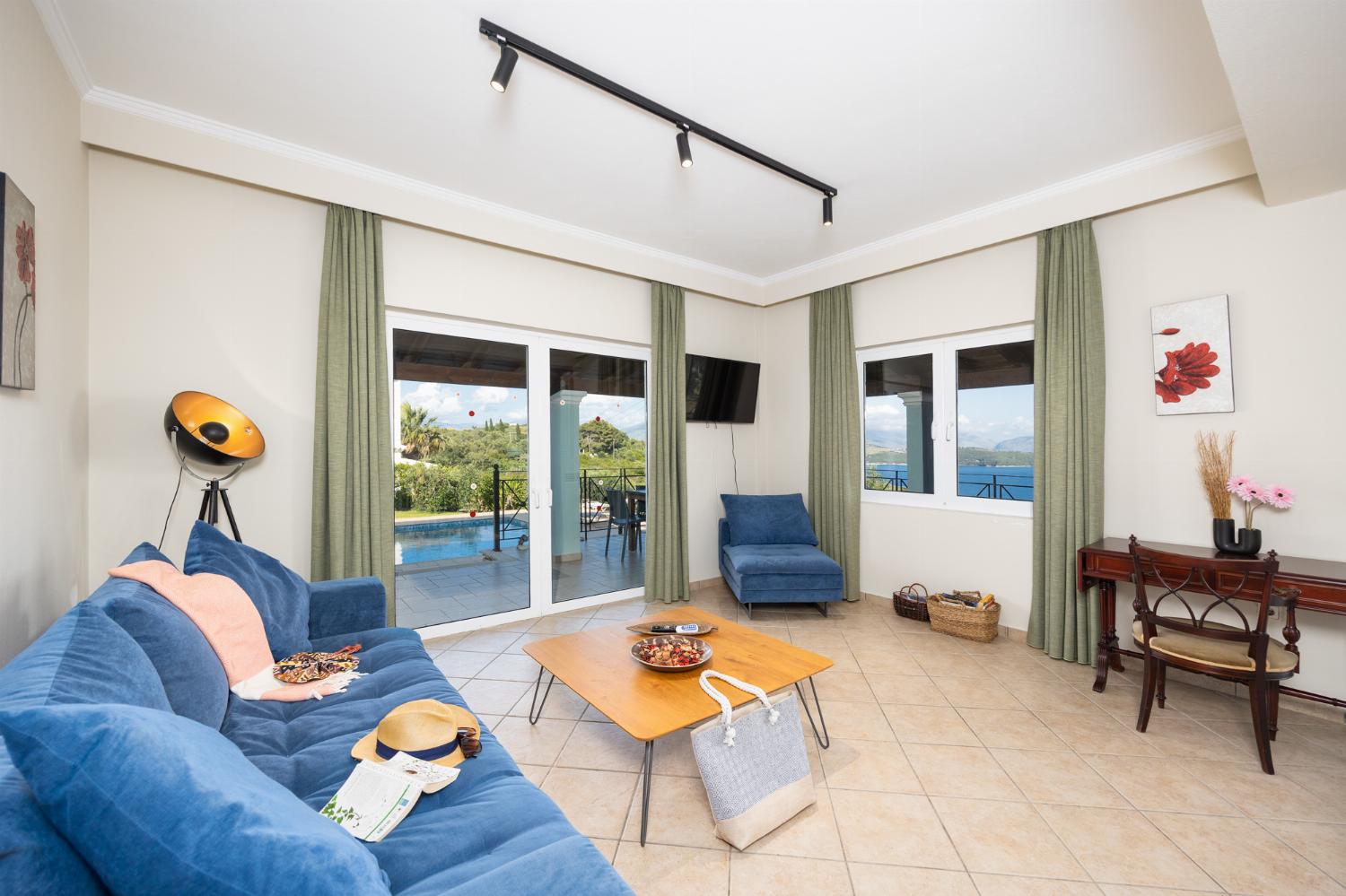 Open-plan living room with sofa, dining area, kitchen, WiFi internet, satellite TV, and sea views