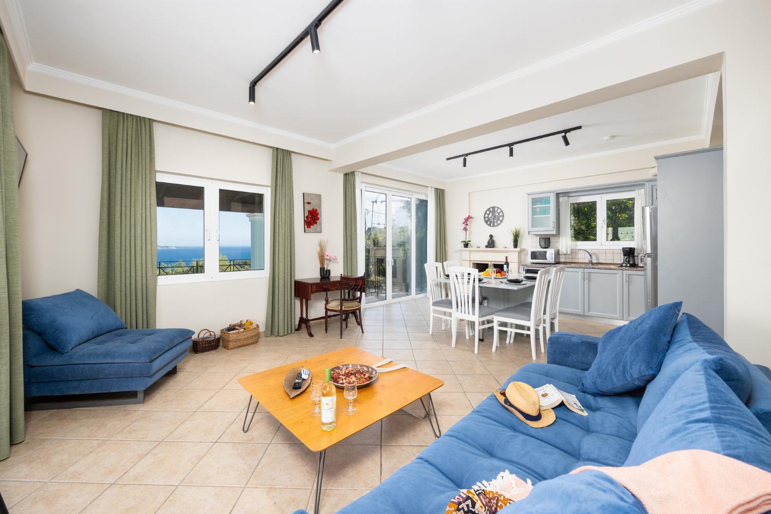 Open-plan living room with sofa, dining area, kitchen, WiFi internet, satellite TV, and sea views