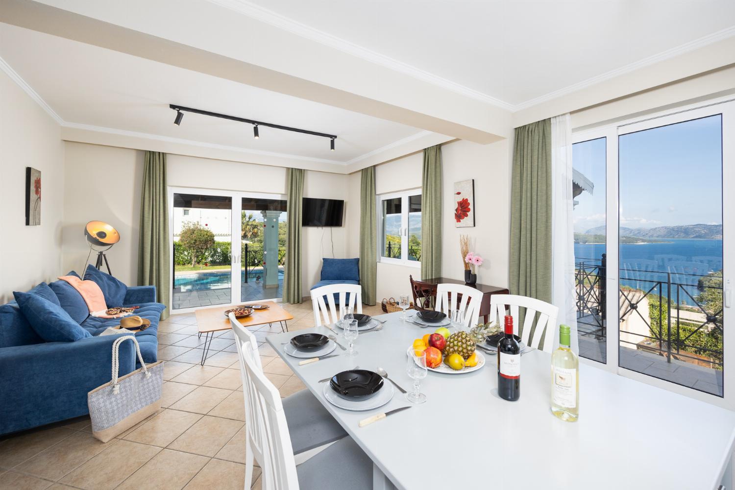 Open-plan living room with sofa, dining area, kitchen, WiFi internet, satellite TV, and sea views