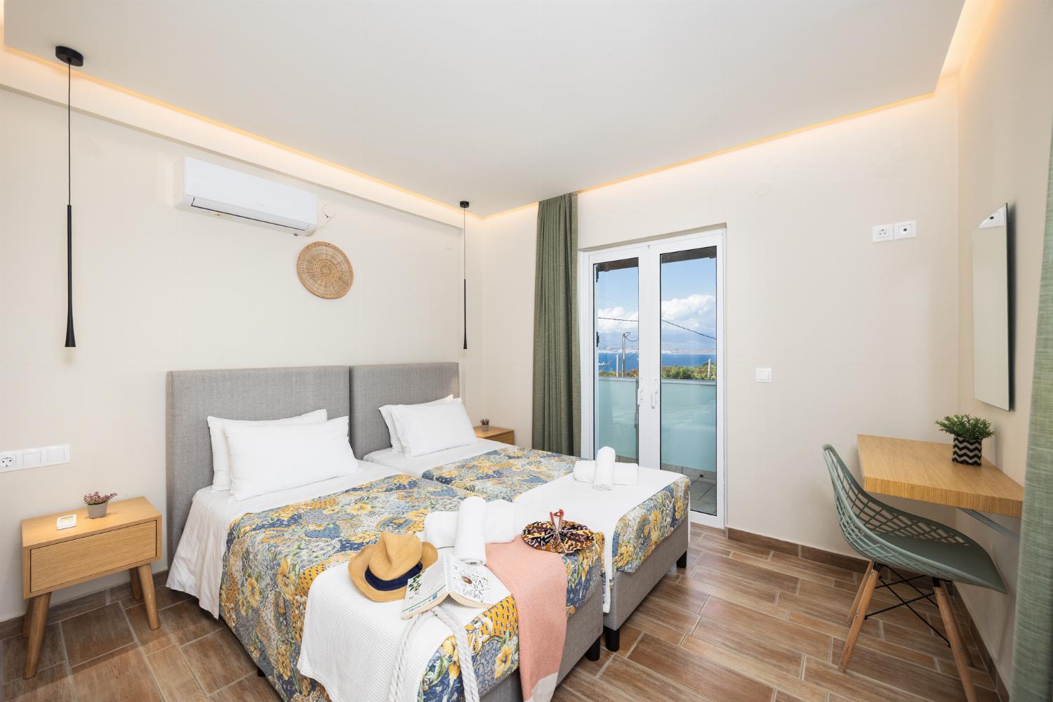 Twin bedroom with en suite bathroom, A/C, and sea views