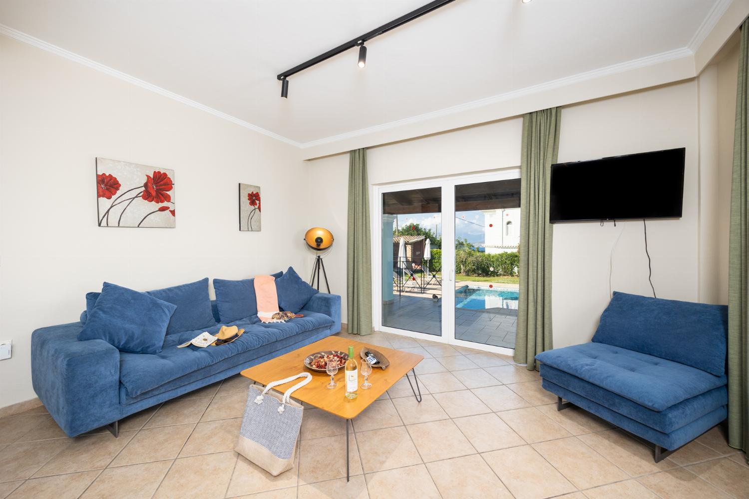 Open-plan living room with sofa, dining area, kitchen, WiFi internet, satellite TV, and sea views