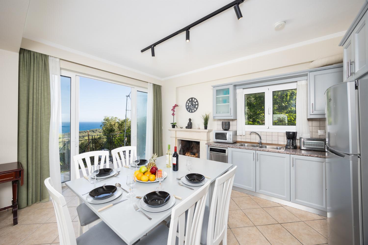 Open-plan living room with sofa, dining area, kitchen, WiFi internet, satellite TV, and sea views