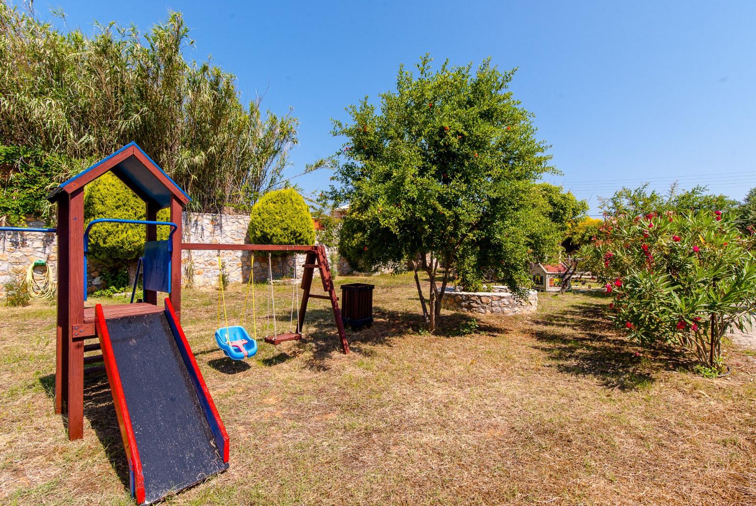 Playground in shared garden area of Eleon Villas