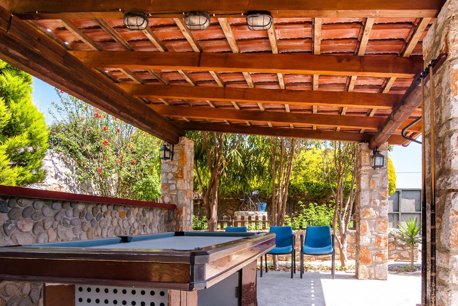 Pool table in shared garden area of Eleon Villas