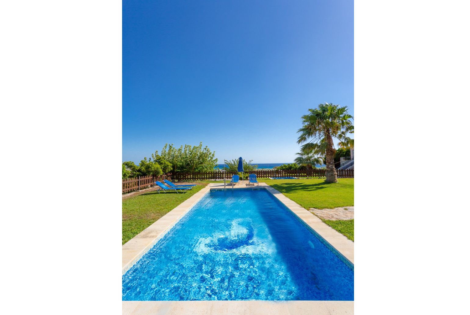 Private pool and lawn with sea views