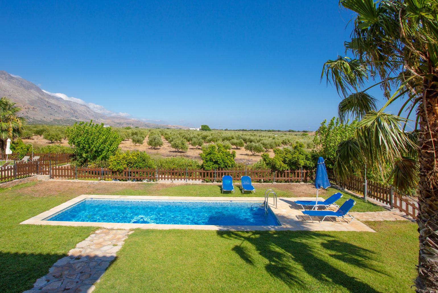 Private pool and lawn with sea views