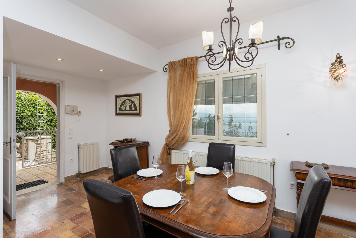 Living room on ground floor with sofa, dining area, ornamental fireplace, WiFi internet, satellite TV, and sea views
