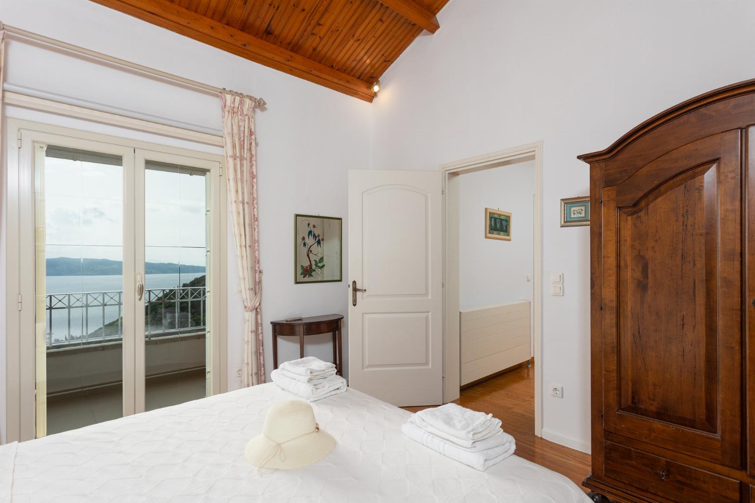 Double bedroom on first floor with en suite bathroom, A/C, sea views, and balcony access