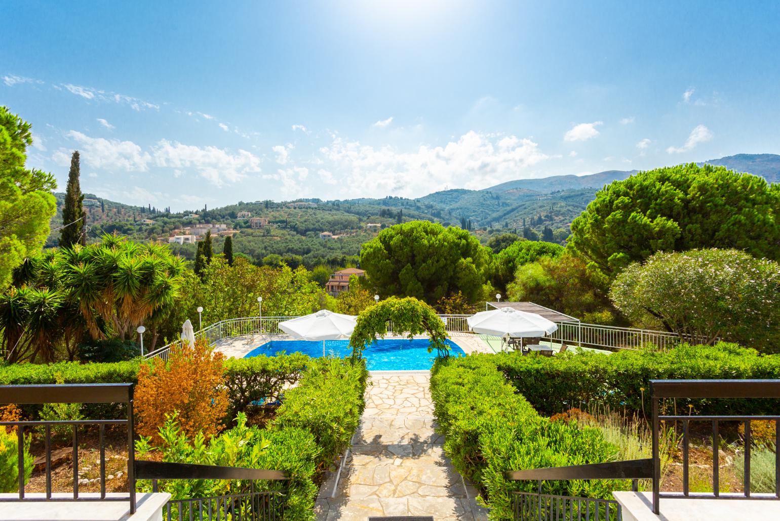 Shared pool, terrace area, and garden with countryside views