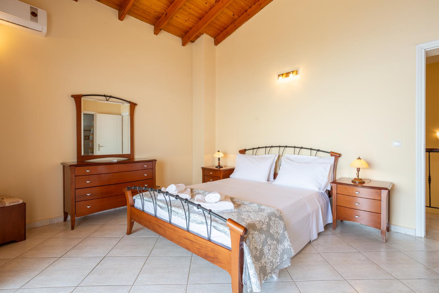 Double bedroom with en suite bathroom, A/C, and upper terrace access with panoramic sea views